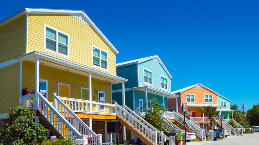 Row of colorful vacation homes in Florida with a beach town vibe under a clear blue sky, symbolizing the perfect beachside getaway.