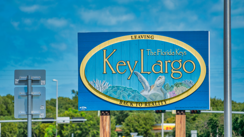 Leaving, going back to reality" sign with ocean turtle, Key Largo, Florida Keys