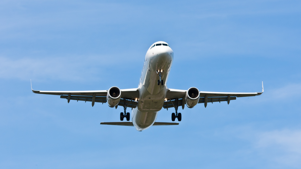 Airplane flying over Florida's blue sky