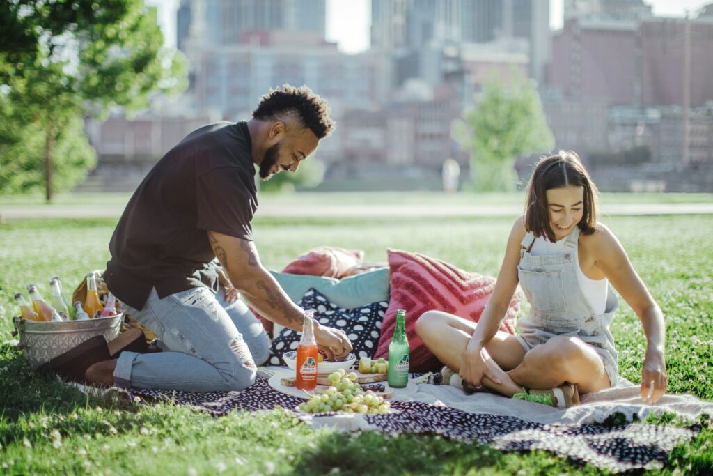 A family at a picnic in Florida, unpacking their basket and preparing to enjoy a meal together outdoors.