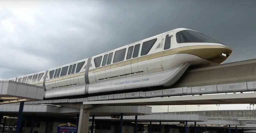 Disney monorail driving by with scenic views